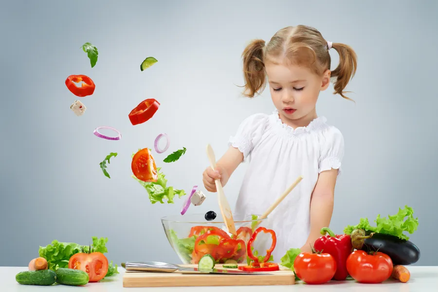 Et barn som hakker grønnsaker