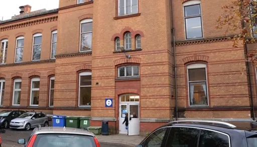 A brick building with cars parked in front of it