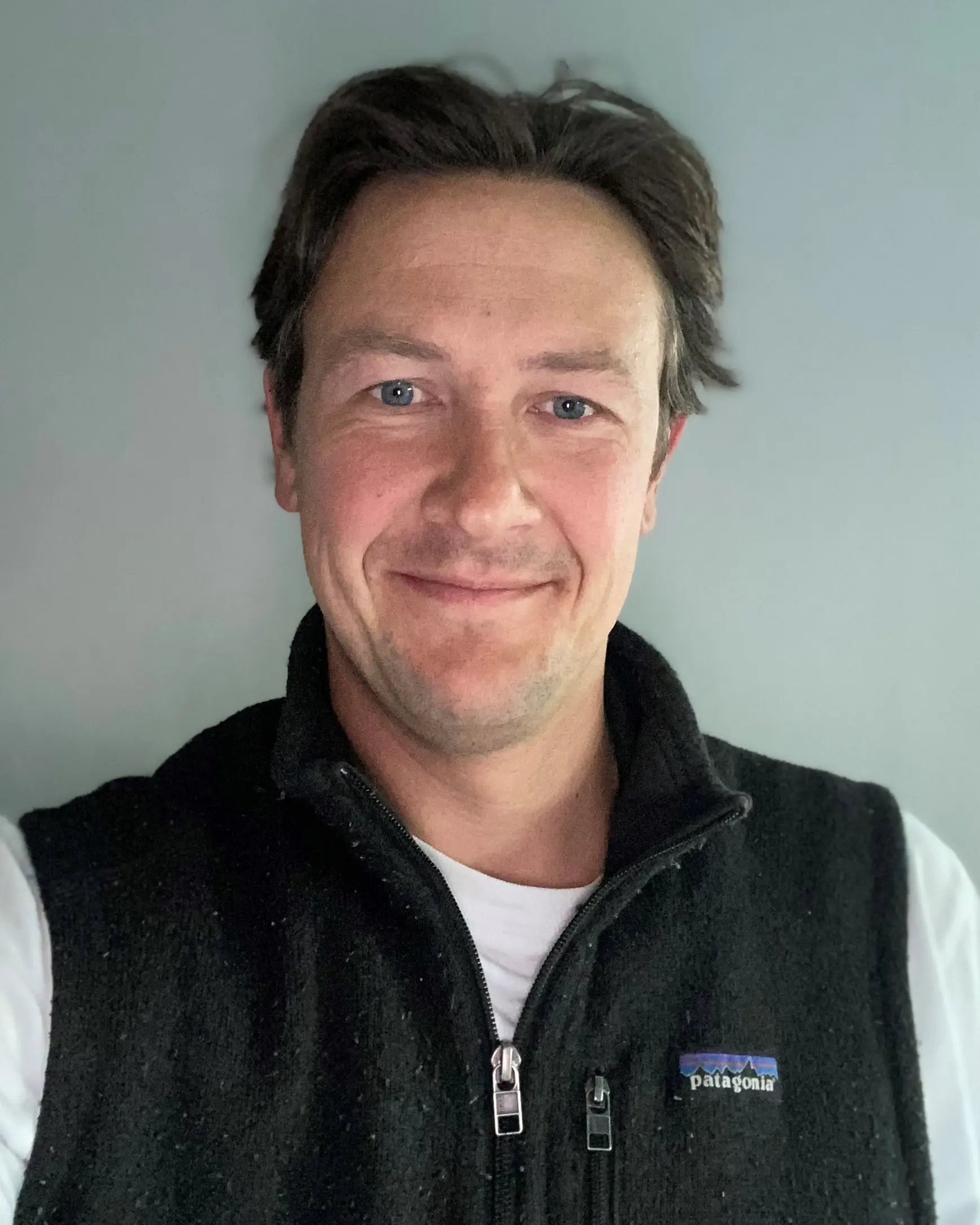 En mann som smiler til kameraet