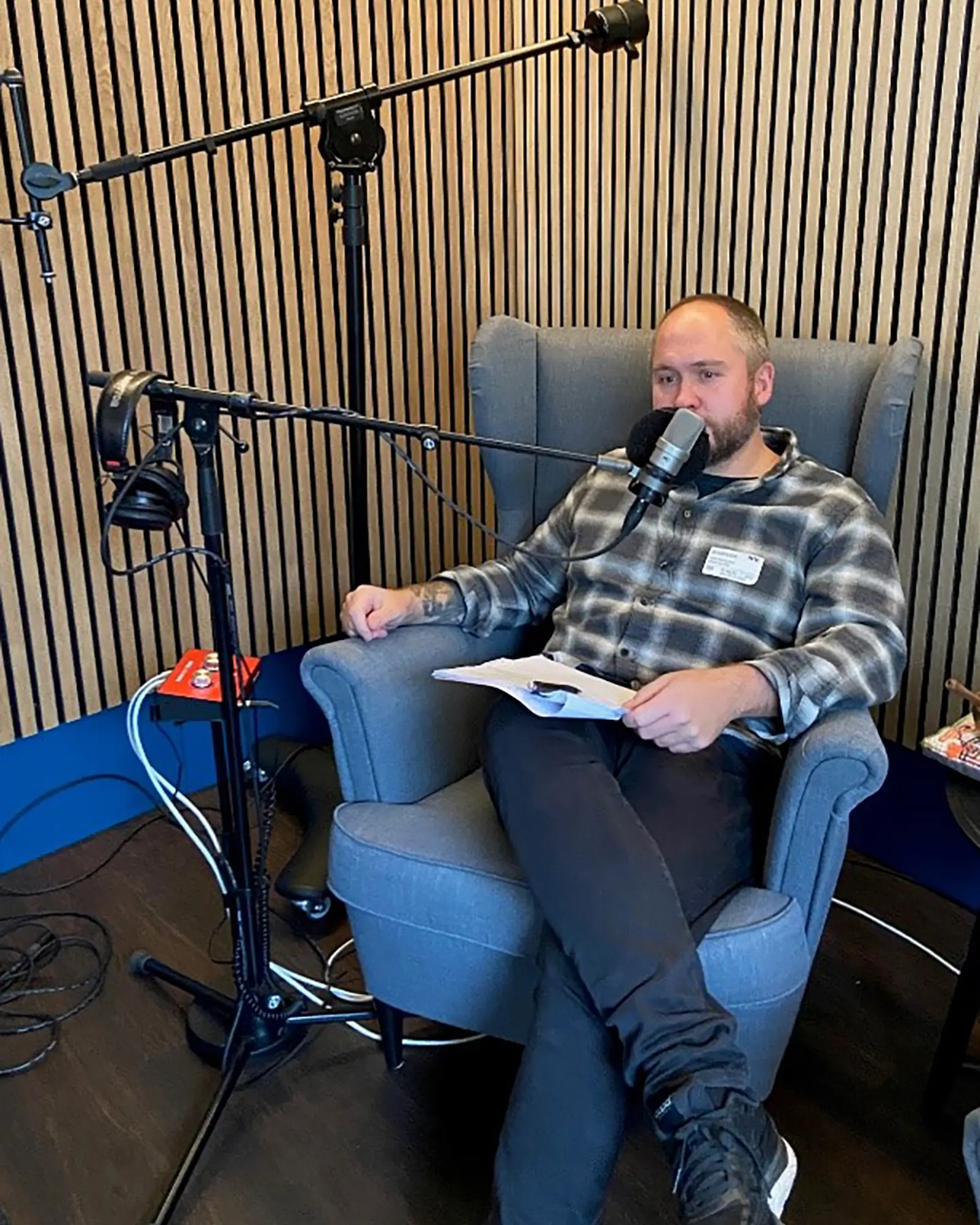 En person som sitter i en stol med mikrofon