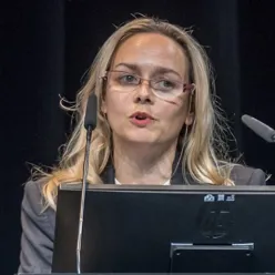 En kvinne som står bak en talerstol