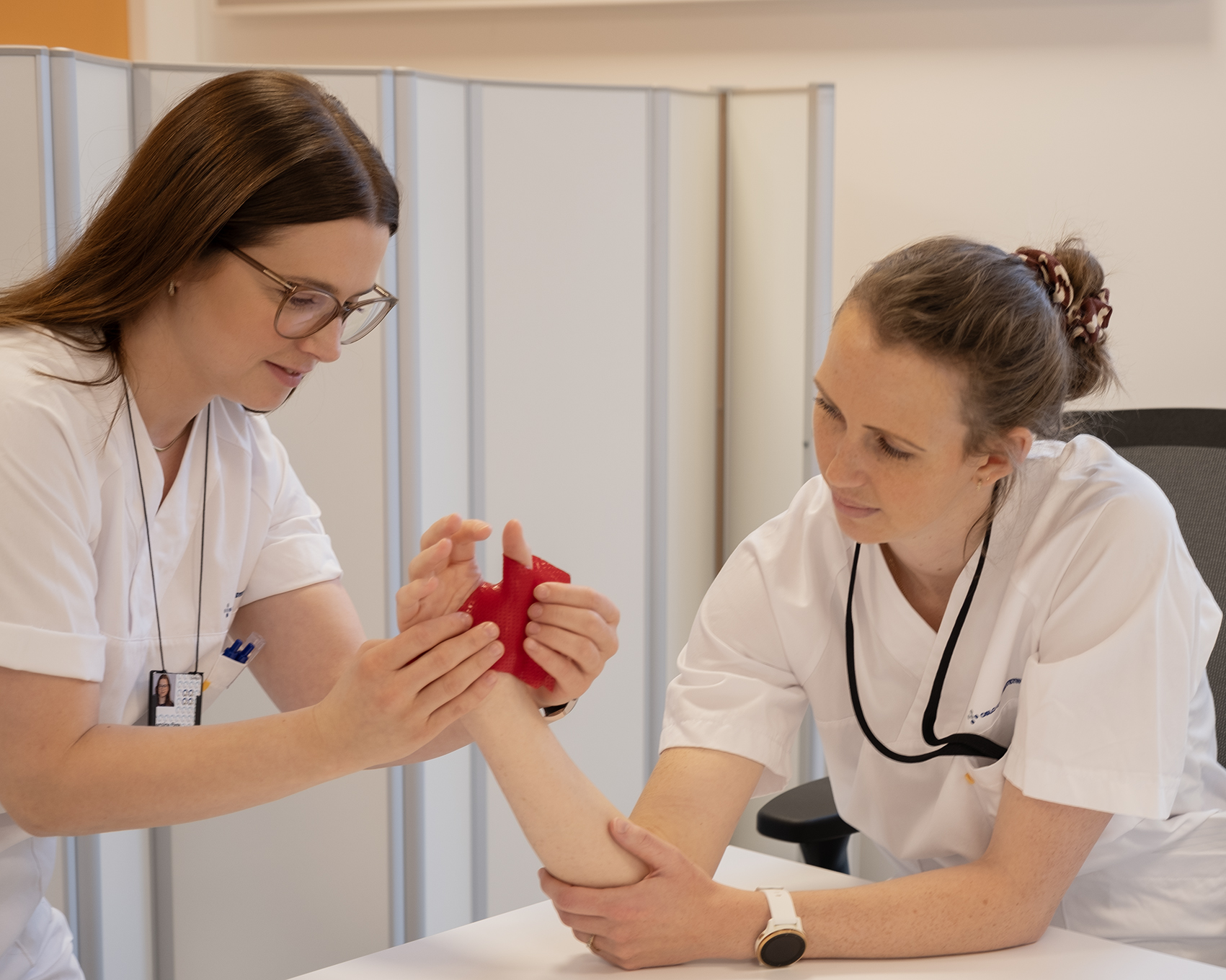 A doctor showing a woman something on the phone
