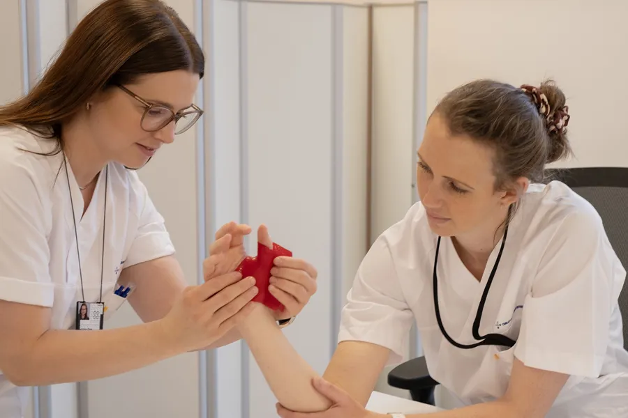 A doctor showing a woman something on the phone