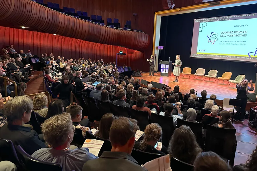 En gruppe mennesker som sitter i et rom og ser på en presentasjon