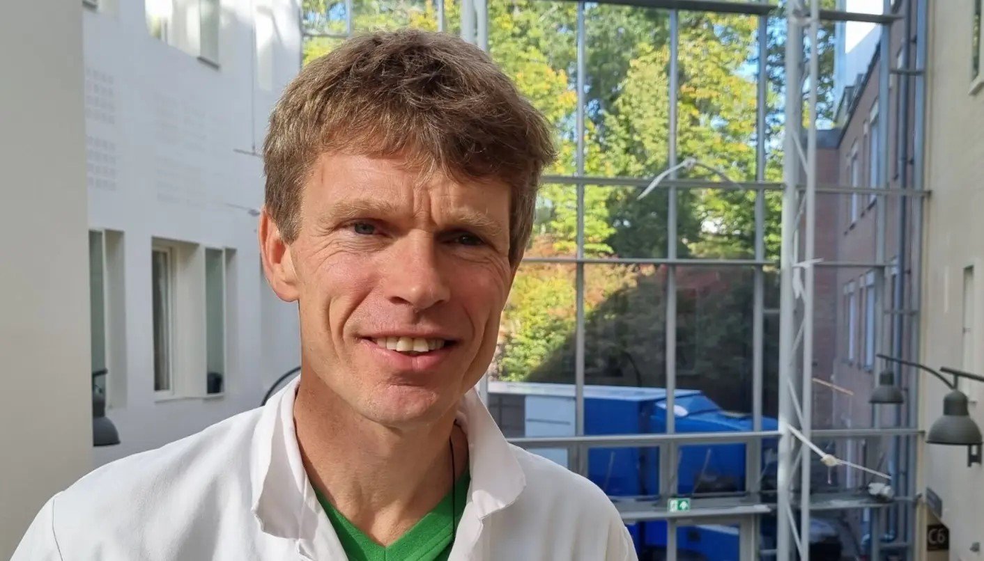 En mann som smiler til kameraet