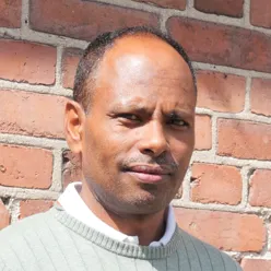 En mann som smiler til kameraet