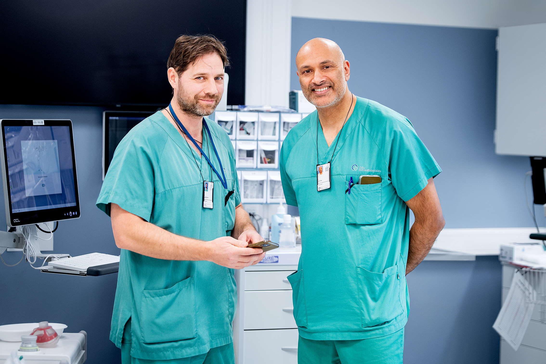 A couple of men in scrubs shaking hands