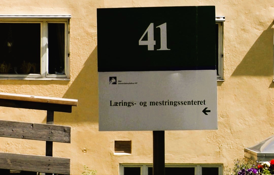 Et skilt med informasjon om bygningene foran hovedinngangen til Aker sykehus