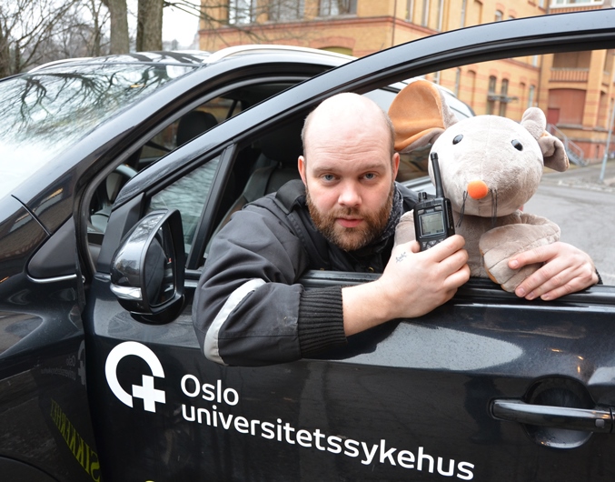 Tøymusen Rasmus sammen med ansatt i sikkerhetsseksjonen