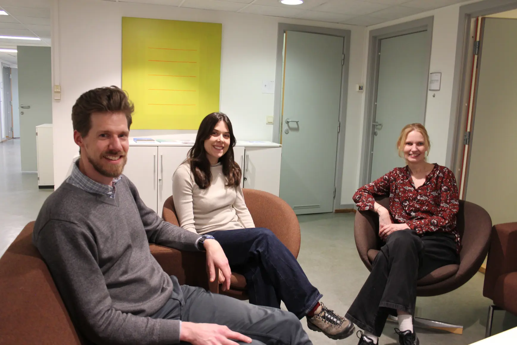 En gruppe mennesker som sitter i en sofa