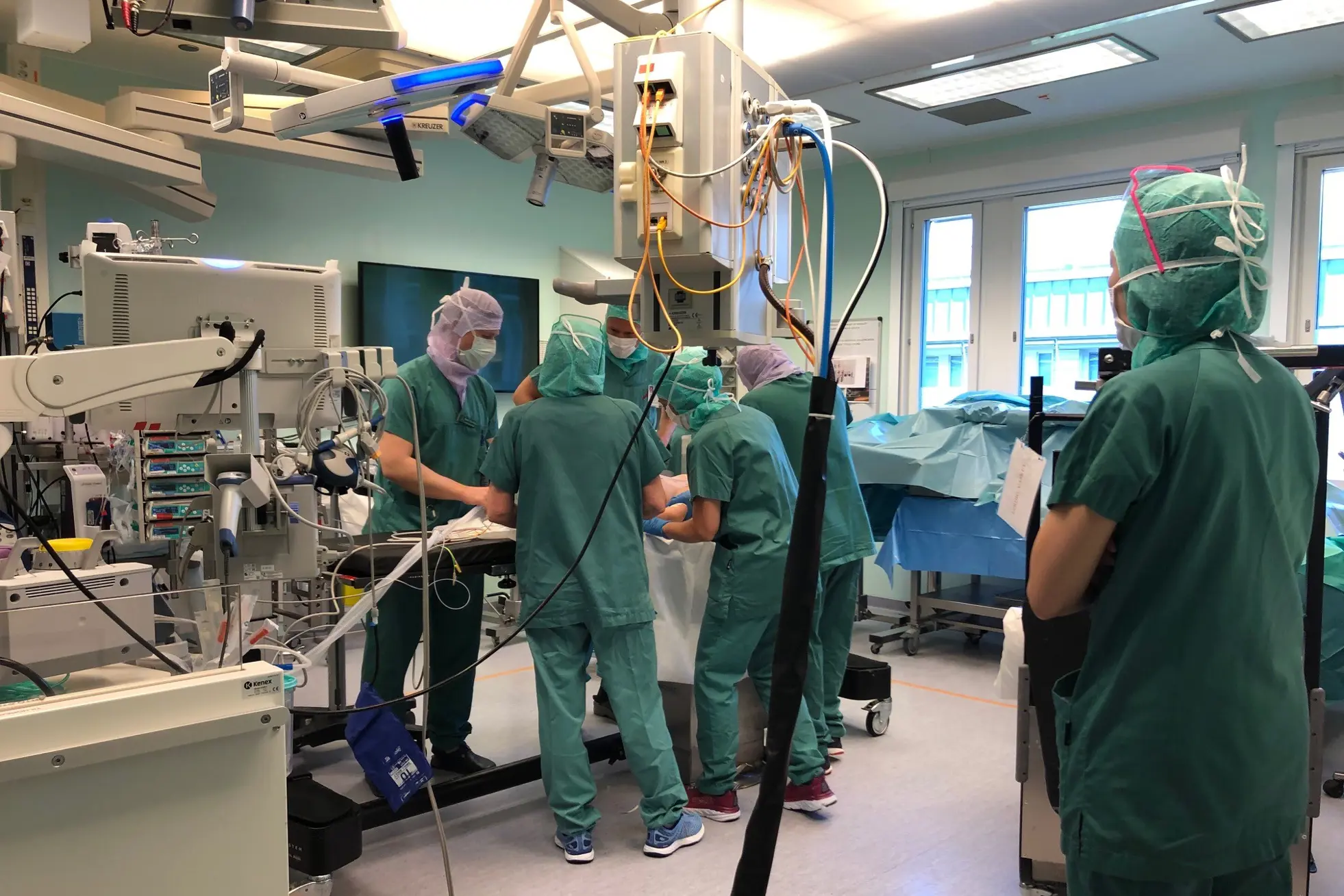 En gruppe mennesker i kirurgiske skrubb i et rom