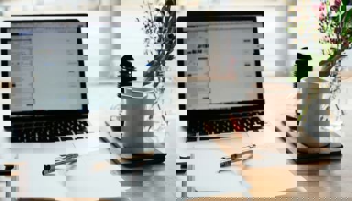 A laptop and a pen on a table