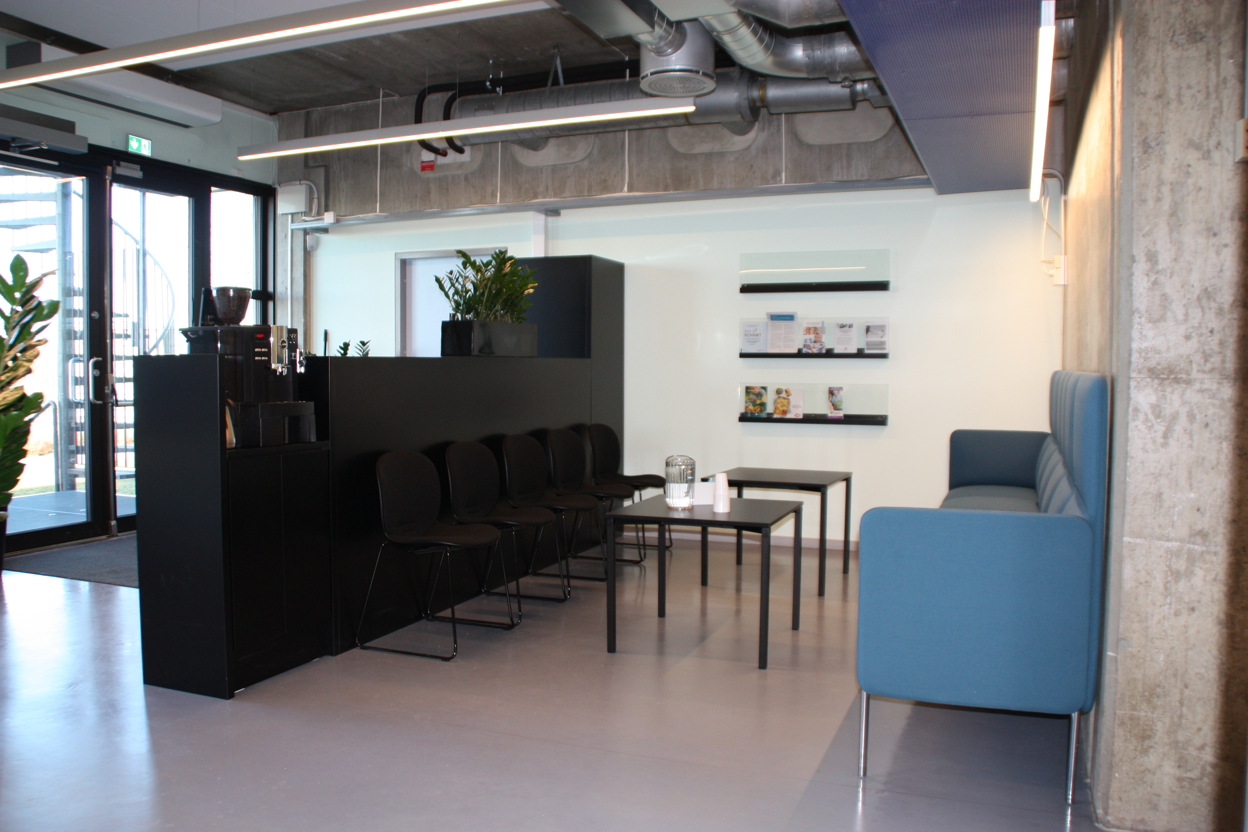 Et rom med bord, stoler og et vindu;