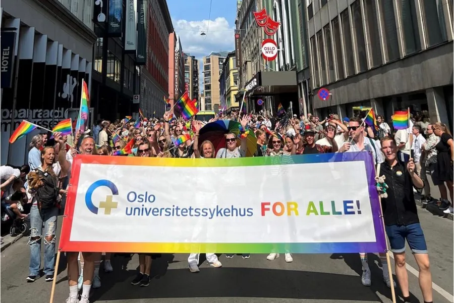 En gruppe mennesker som marsjerer med et banner