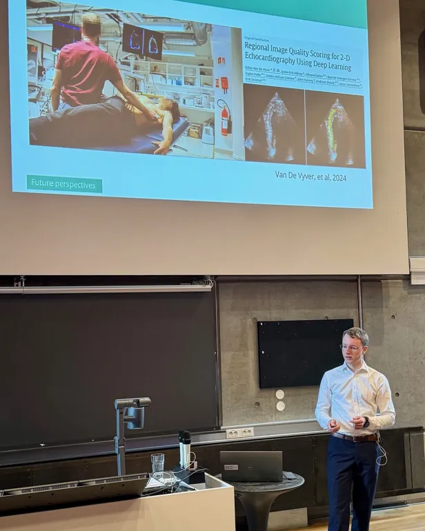 A person standing in front of a projector screen
