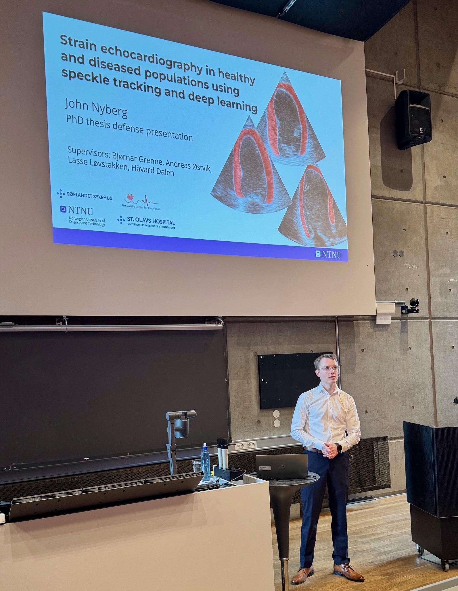 A man standing in front of a projector screen