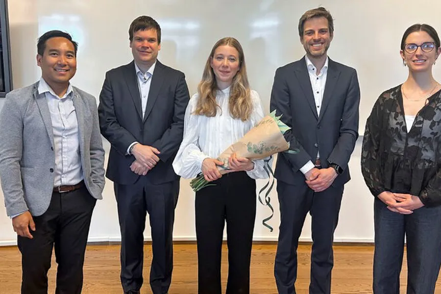 Julie Uv posing with her supervisor and adjudication committee.