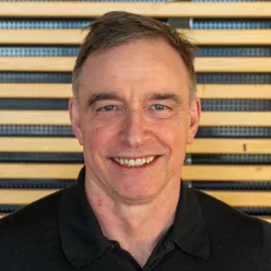 En mann som smiler til kameraet