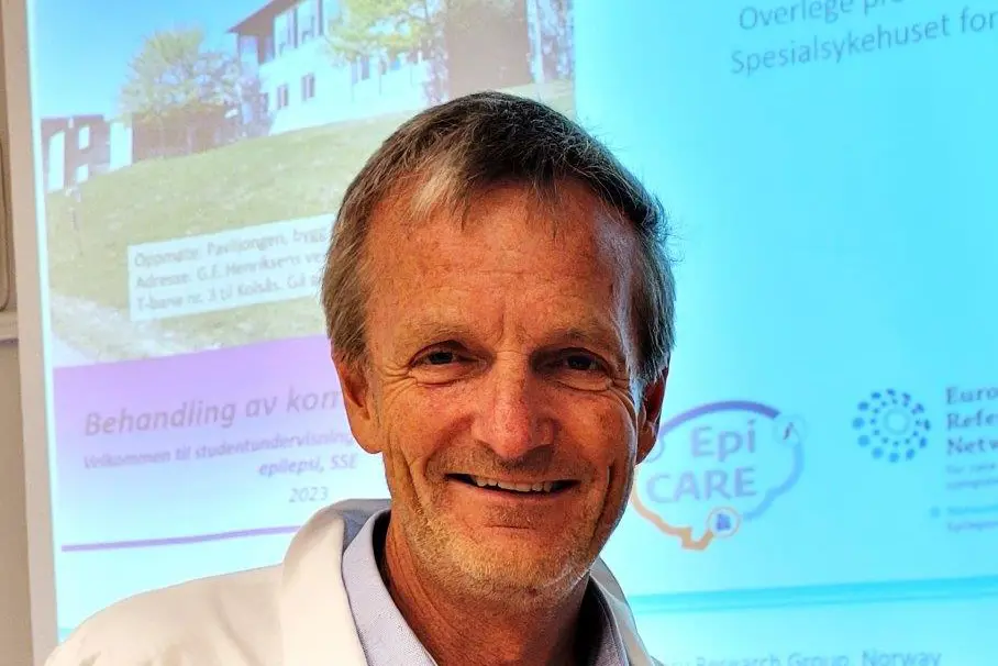 En mann som smiler til kameraet