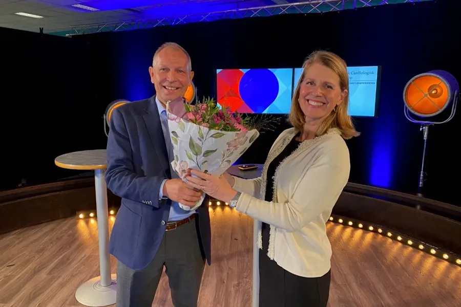 A man and woman holding flowers