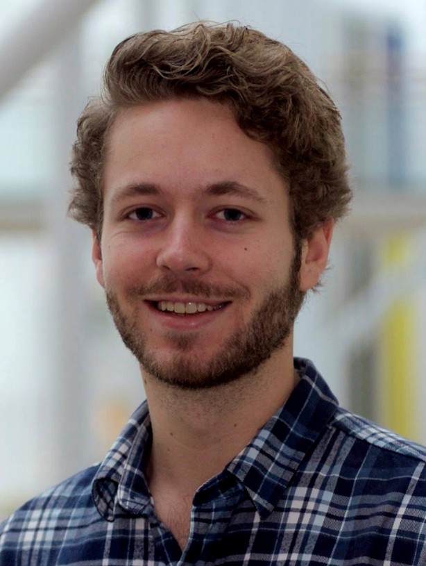 A man with a beard smiling
