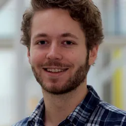 A man with a beard smiling