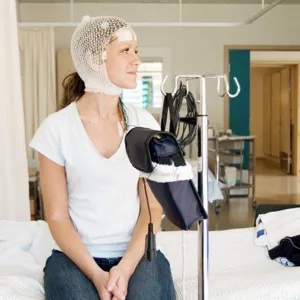 En kvinne som sitter på en seng