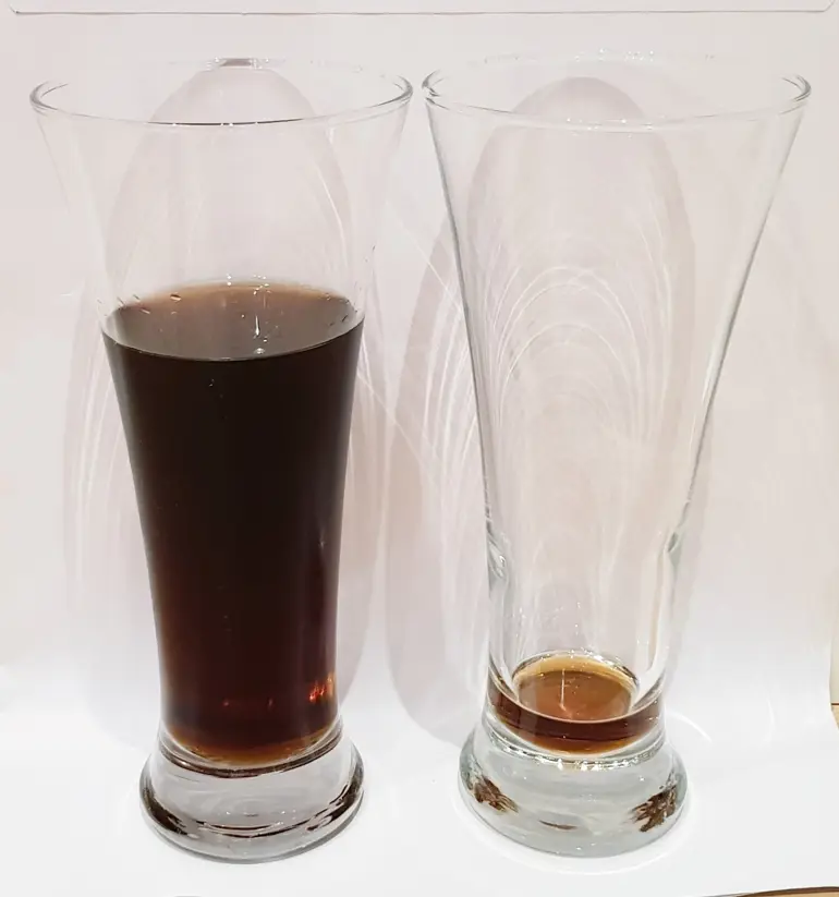 Et par glass med brun væske