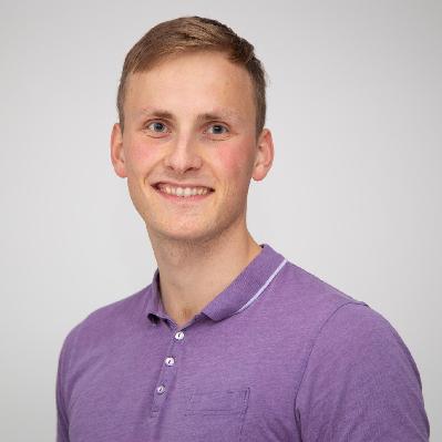 A man wearing a purple shirt