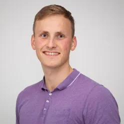 A man wearing a purple shirt