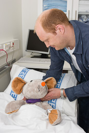 En mann som holder en bamse