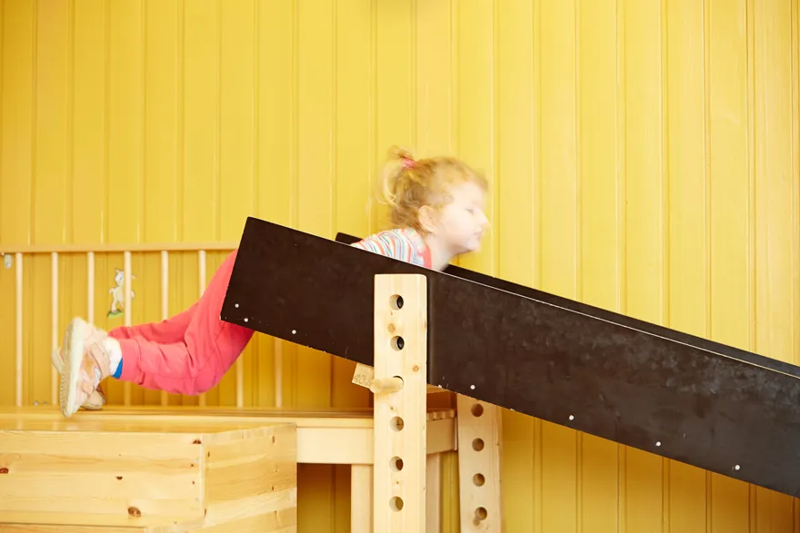 En jente som klatrer på en trekonstruksjon