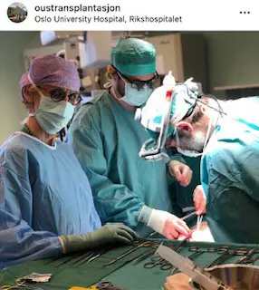 Tre kirurger som holder på å transplantere.