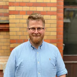 A man with a beard and glasses