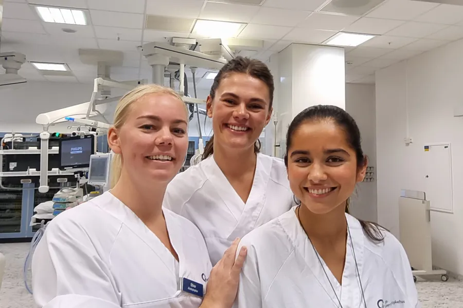 3 female hospital staff in white uniforms