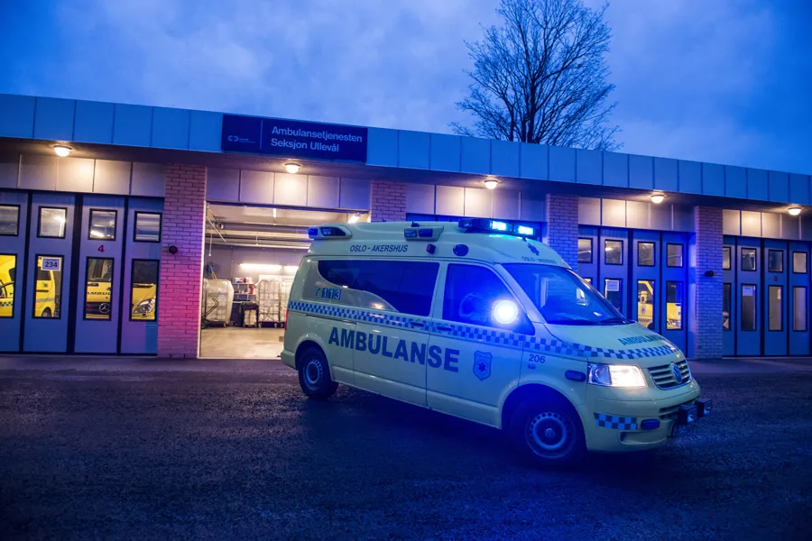 Ambulanse kjører ut av garasjen i grålysningen