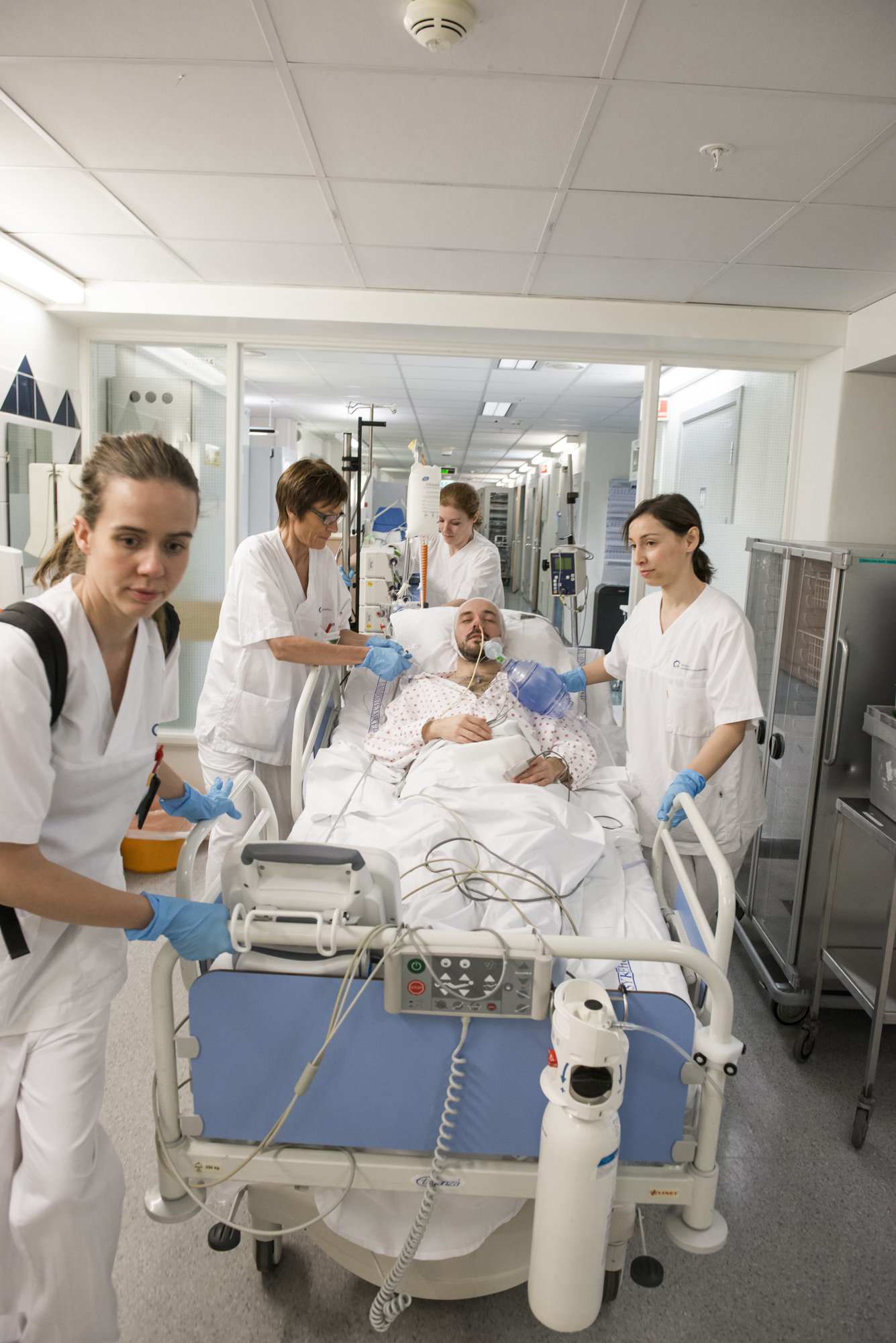 Bilde av sykepleiere som transporterer en intensivpasient i seng