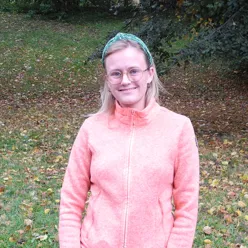A person wearing a pink shirt