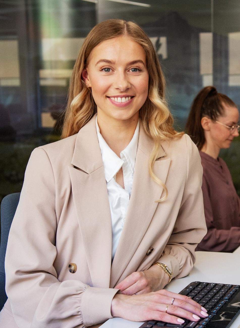 A person in a suit smiling
