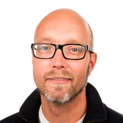 A bald man wearing glasses