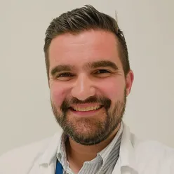 A man with a beard smiling