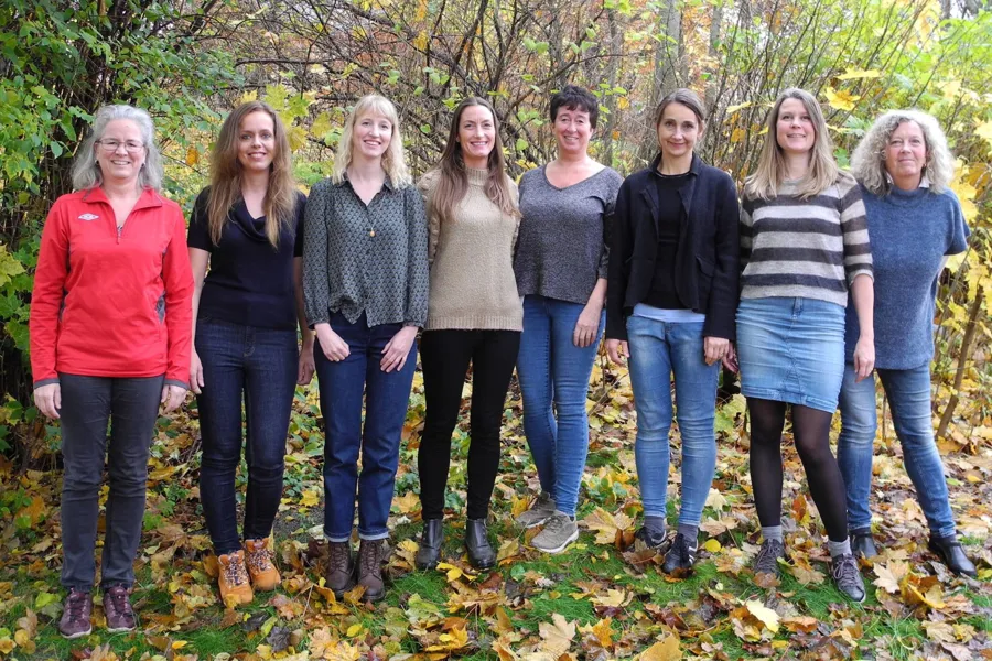 A group of women standing in a forest