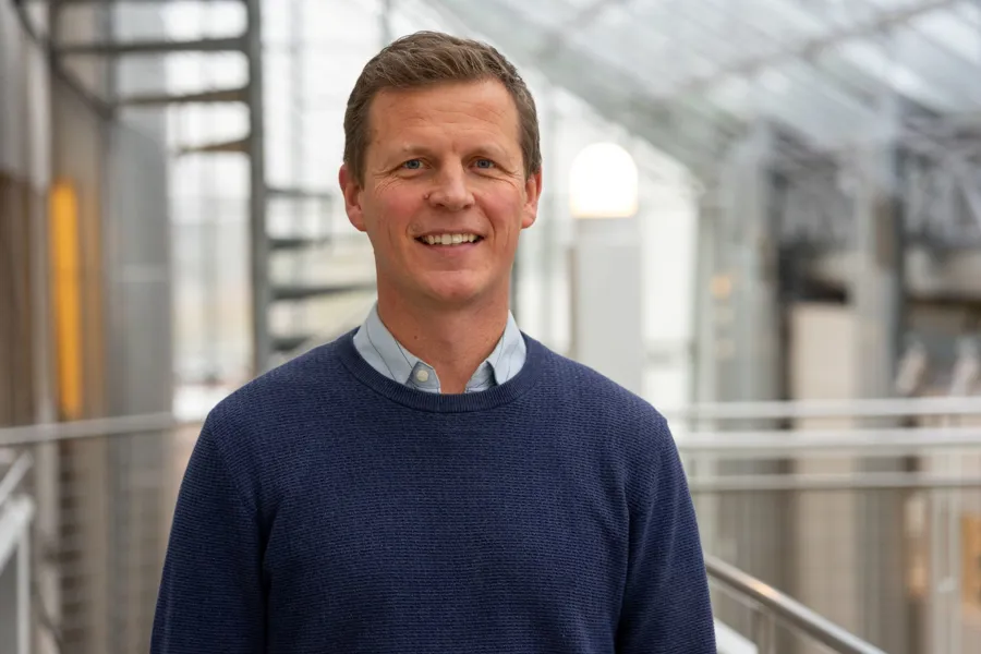 En mann som smiler til kameraet