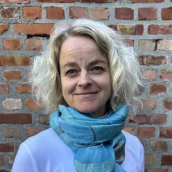 En kvinne som smiler til kameraet