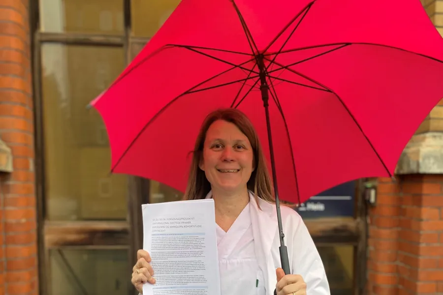 En person som holder en rød paraply