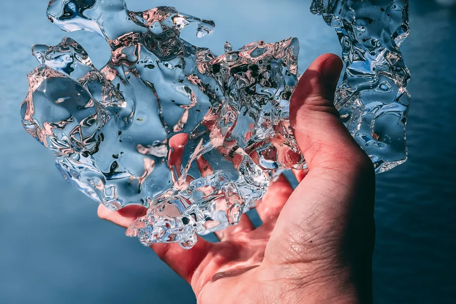 A hand holding a crystal